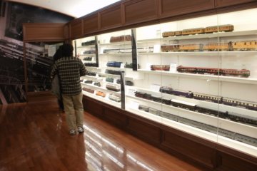 Visitors look at Mr. Hara's trains.