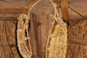<p>Handmade shoes with a bug hanging out around them.</p>