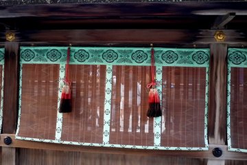 <p>Rattan blind with brocade edging and large tassels</p>