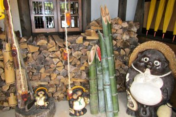 <p>Stacked wood for the fire places and traditional cut bamboo and tanuki statues keep the Japanese countryside mood.</p>