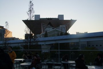 <p>An outdoor cafe with a view of the Conference Tower</p>