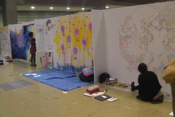 <p>Artists at work at Design Festa, held in Tokyo Big Sight</p>