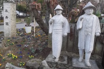 <p>These two chaps stand at the park's entrance, across the road from the station</p>