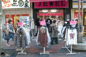 <p>The melting pot: rails of bargains outside a clothes store next to a ramen shop.</p>