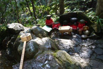 <p>Tiny statues with red aprons</p>