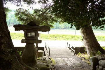 <p>Stone lantern belonging to a small shrine</p>