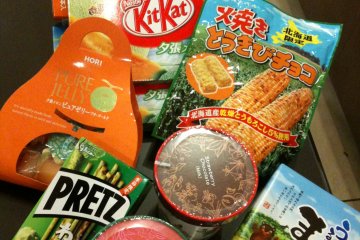 Though it rained non-stop, we were all smiling because we collected a hug bag of snacks from every stop (mine, all mine). The round green thing you see is the marimo BTW.


