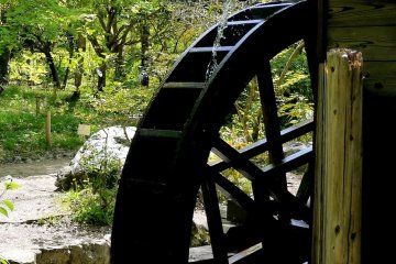<p>A water wheel powers a small but functioning mill</p>