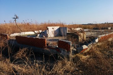 <p>Bricks and a cement foundation slowly being forgotten as the grass grows.&nbsp;</p>