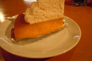 <p>My husband's dessert: rich, sweet, Japanese version of pumpkin pie topped with cream (250 yen). I think I might opt for that next time. I ordered cheesecake (270 yen) which was good, but needed fruit or some other flavor besides sugar. What a great big dose of sugar! We refreshed after dessert with a glass of water</p>