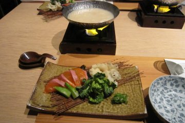 <p>Shabu-Shabu of cherry trout? and new brown seaweed. These white mushrooms are called 'Flower Petal mushroom'. The soup is made of sake lees...how intricate!</p>