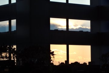 Looking out the huge, tall, floor-to-ceiling windows, only one-sixth of the view includes far-away mountains, buildings and the city; the remaining five-sixths is filled with the deep blue sky, or stunning orange evening glow.