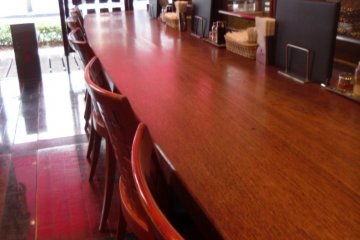 <p>The restaurant has a very professional atmosphere. Off to the right is the grill, where you can see (and smell) gyutan being cooked.</p>