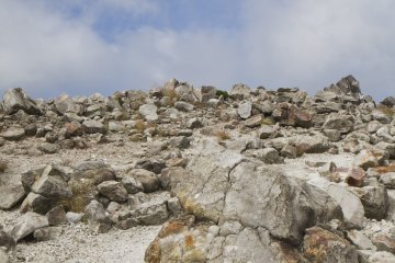 Volcanic boulders ring the crater of Mt. Io