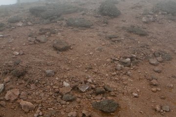 Au sol, prêt du sommet, la poussière de roche est rouge