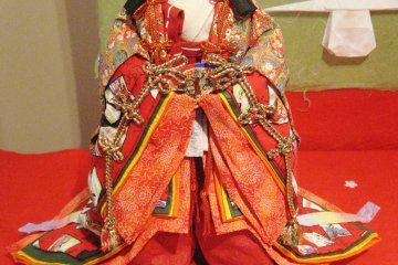 Intricate detail on the origami clothing of a doll