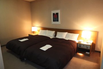 <p>The Deluxe Rooms&rsquo; bedroom</p>