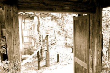 <p>Gate leading to a path winding its way up the hill to a great view, a small shrine, and a bamboo grove</p>