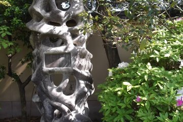 <p>A monument in the shade of the trees alongside the main path</p>