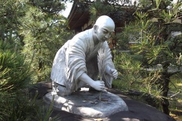 <p>A statue of Saint Zoyo, founder of the&nbsp;temple, who planted trees along the local coastline to protect the townspeoples' crops from salt damage</p>