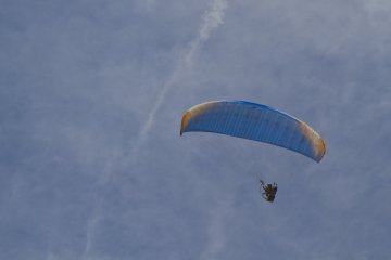 <p>Ada penerjun payung skyrider yang sedang terbang di atas kepala kit</p>
