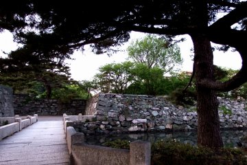 <p>Gejo Bridge and a pine tree. Look closely at the colorful stones on the wall</p>