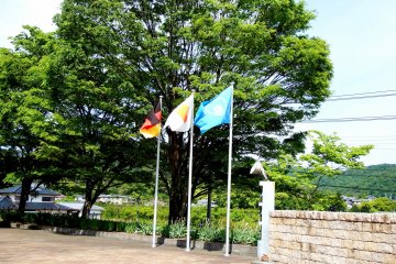 <p>Billowing flags of Germany, Japan and Naruto city</p>