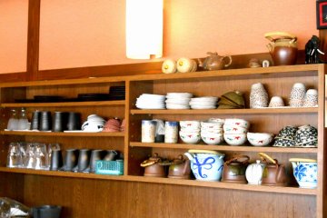 <p>Many Otani Pottery dishes lined up on the shelves</p>