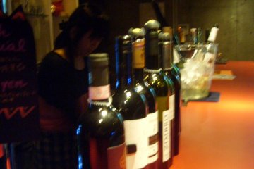 More wine on the bar (or possibly the same wine from a different angle)