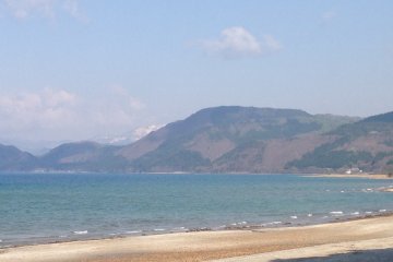 <p>Beautiful blue waters with the distant mountains devoid of civilization.</p>