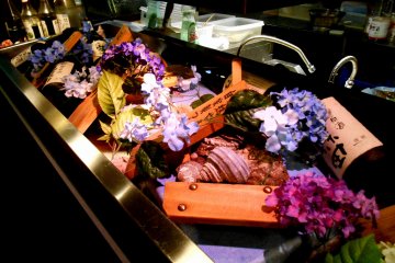 <p>Fresh fish displayed with flowers. Nice!</p>