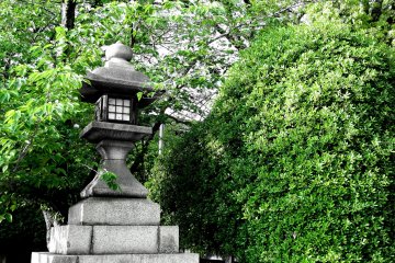 <p>Stone lantern and green trees</p>