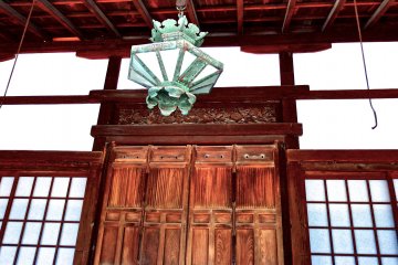 <p>Bronze lantern hanging from ceiling</p>