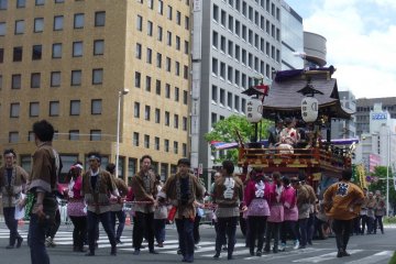 <p>The other main part of the parade are the giant wheeled floats, called Yamaboko, sponsored by various companies and organizations in Sendai. Each one is uniquely decorated and is pulled by a team of people.</p>