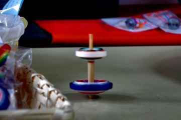 <p>Small Kyo Koma on top of larger one. I tried it many times but couldn't even make one spin like that. It takes skill to do this!</p>