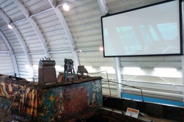 <p>Stairs lead to a viewing platform. You can also see a projected video on the opposite wall.&nbsp;</p>