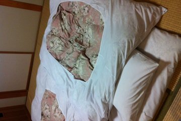 Futon bed set up for you while you are at dinner.  Table and chairs are set off to the side of the room.