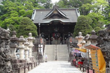 <p>Pathway lined with stone lanterns and a set of steep stairs up to the second gate</p>