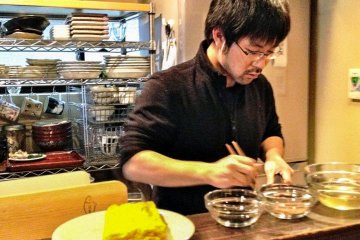 Teacher Taro san on a roll in the kitchen, chatting, cooking, laughing, all the same time