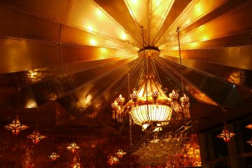 <p>The beautiful ceiling illuminated with a golden chandelier.</p>