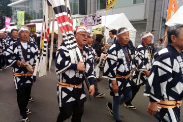 A firemen's association in traditional ware make their way through the crowd.&nbsp;