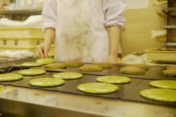 <p>Carefully preparing the matcha pancakes.&nbsp;</p>