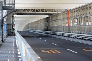 <p>Cars have their own lanes, as do pedestrians who walk the bridge, and the trains are also on the same level on the right side.&nbsp;</p>