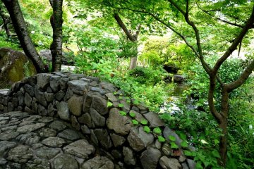 <p>An arched stone bridge crosses the pond &nbsp;</p>