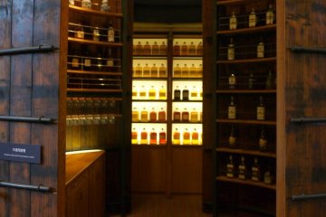 <p>Wooden shelves lined with whiskey bottles create a wonderful atmosphere</p>