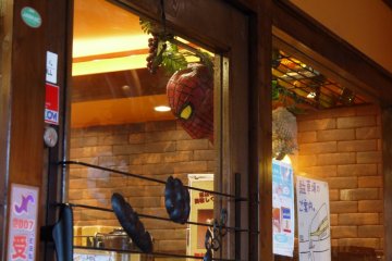 <p>A Spiderman mask hangs next to the door</p>