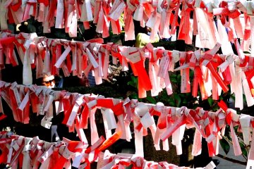 <p>Red and white omikuji papers</p>