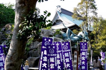<p>Dragon statue surrounded by purple banners</p>