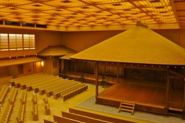 The stage of Noh is in the right corner of the theater and a long corridor connects the stage with the left wing. The audience seats are set in three directions facing the stage.
