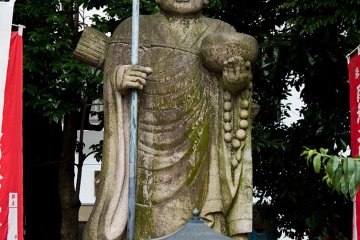 <p>A buddhist statue stands in the grounds</p>